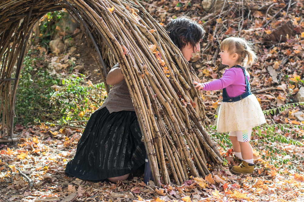 A little girl plays with her mother in the forest at Ijams Nature Center.