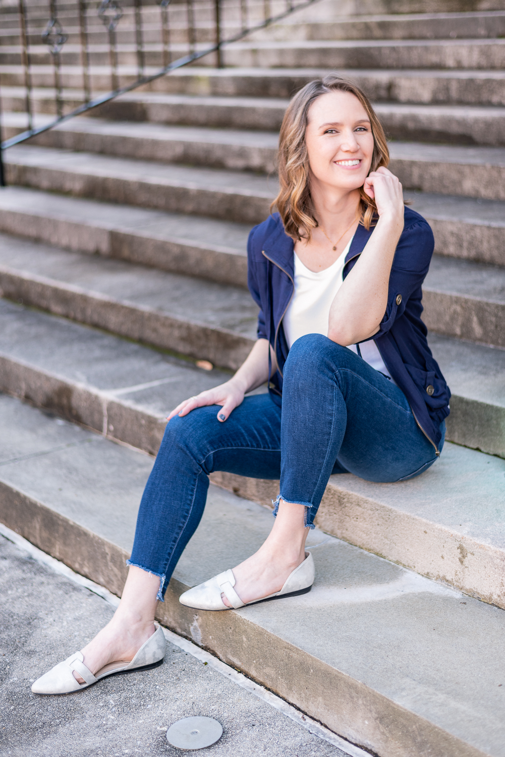Woman sitting on steps and smiling in downtown Knoxville, TN.