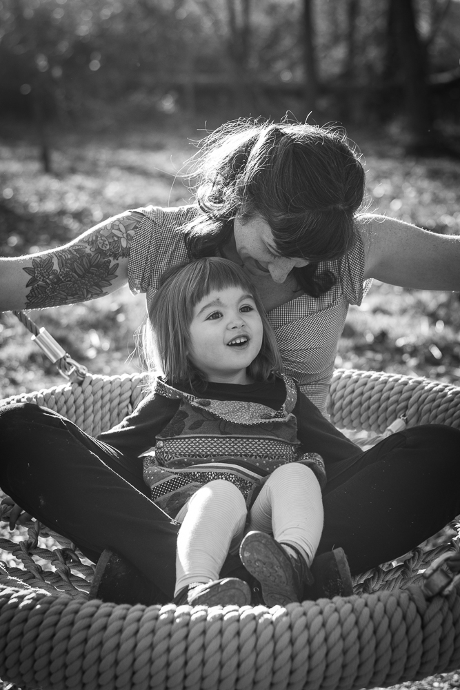 Mother and daughter in a swing at the Baker Creek playground.