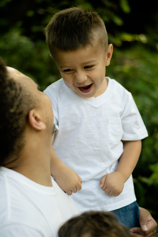 Little boy smiling excitedly at his father.