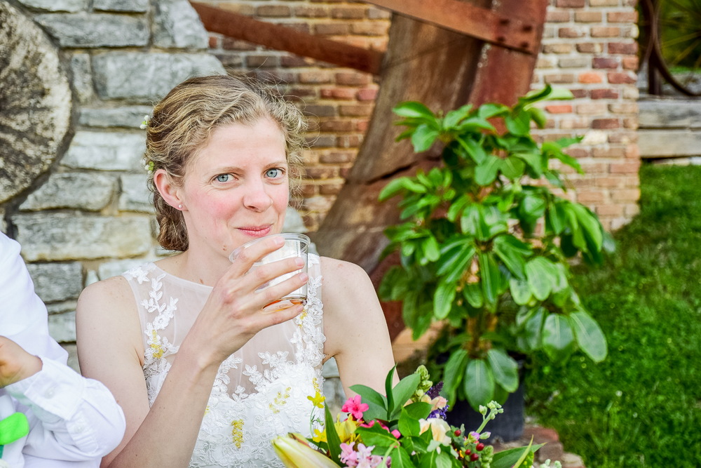 Bride drinking whiskey after vows at Museum of Appalachia.