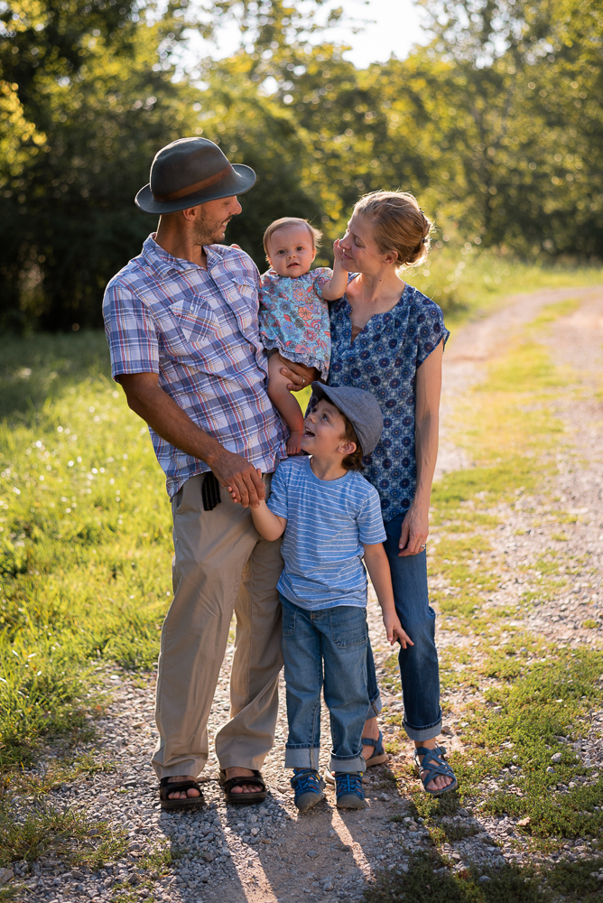 Family of four's portrait on a gravel road.