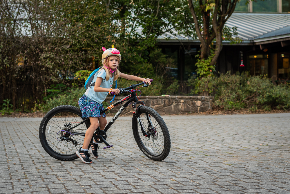 A little girl with a unicorn helmet rides her bike at Ijams Nature Center for Pedal Jam Knoxville.