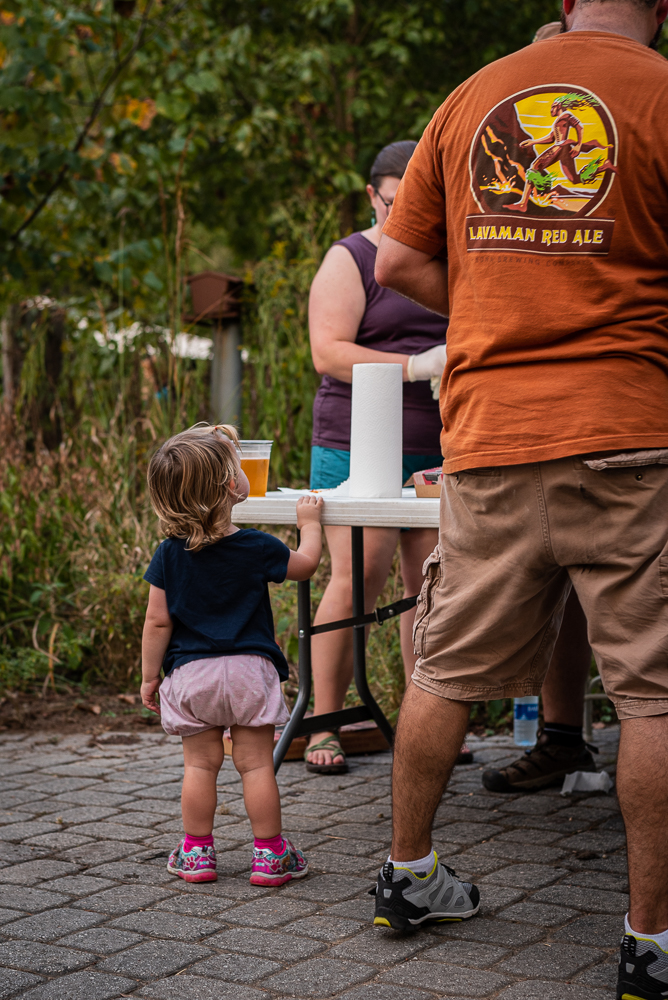 A toddler hangs out with her father at Pedal Jam Knoxville at Ijams Nature Center.