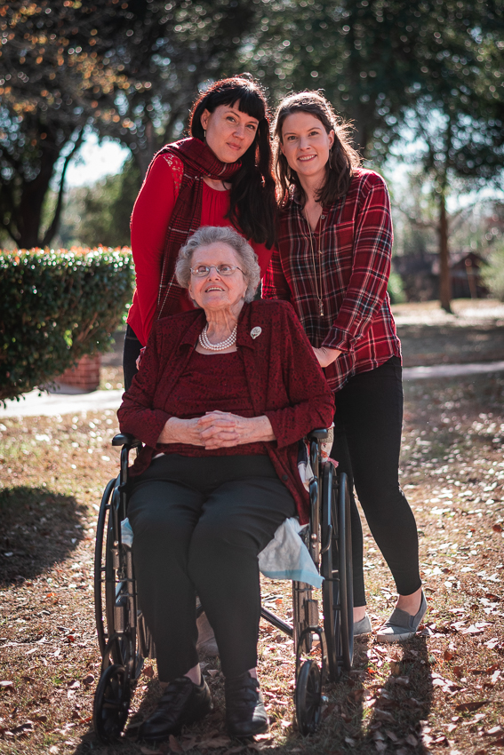 A portraits of my sister, my grandmother, and me outside at Christmas.
