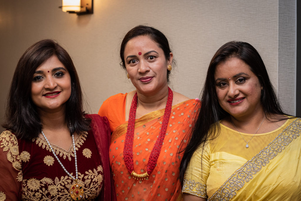 Three women in saris at a Bratabandha ceremony.