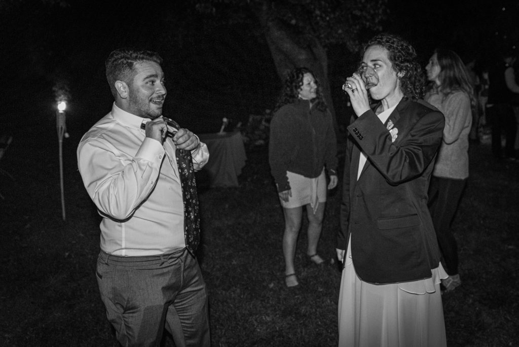 A bride and friend talk during the evening dance party at a wedding.