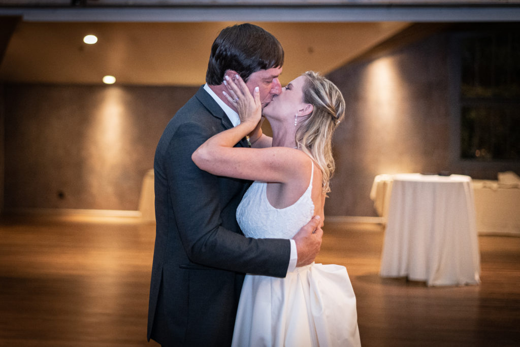 The bride and groom kiss during their first dance.