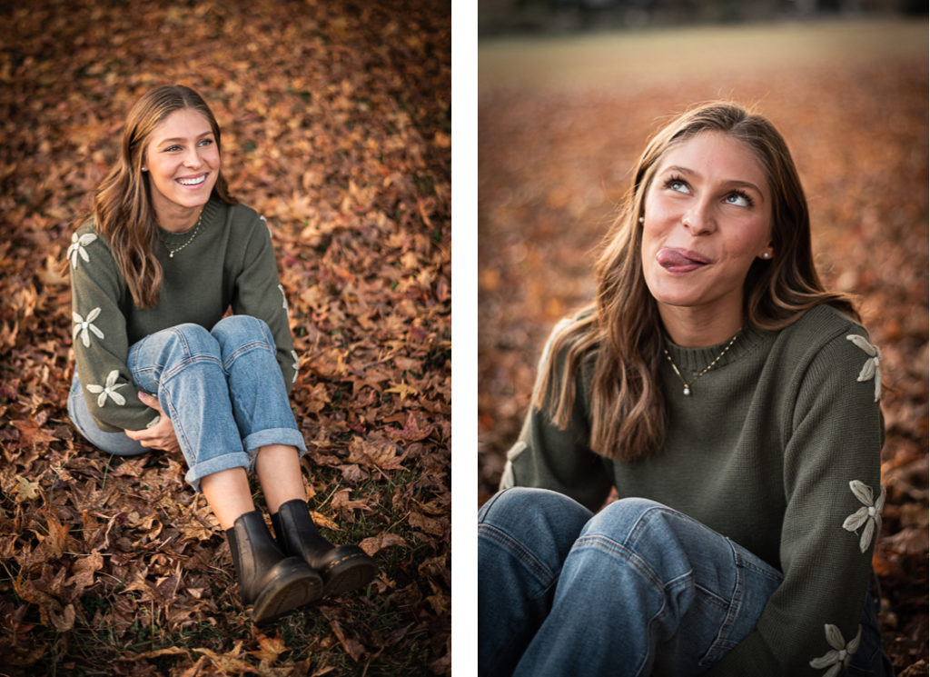 A female student sits in the fall leaves for her senior portraits.