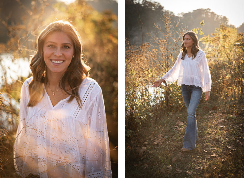 A female high school senior in a white blouse poses for senior portraits by the Tennessee River.