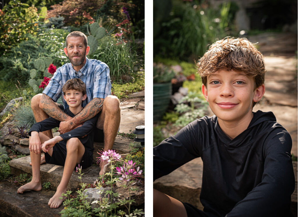 A boy and his father sit in the lush backyard garden.