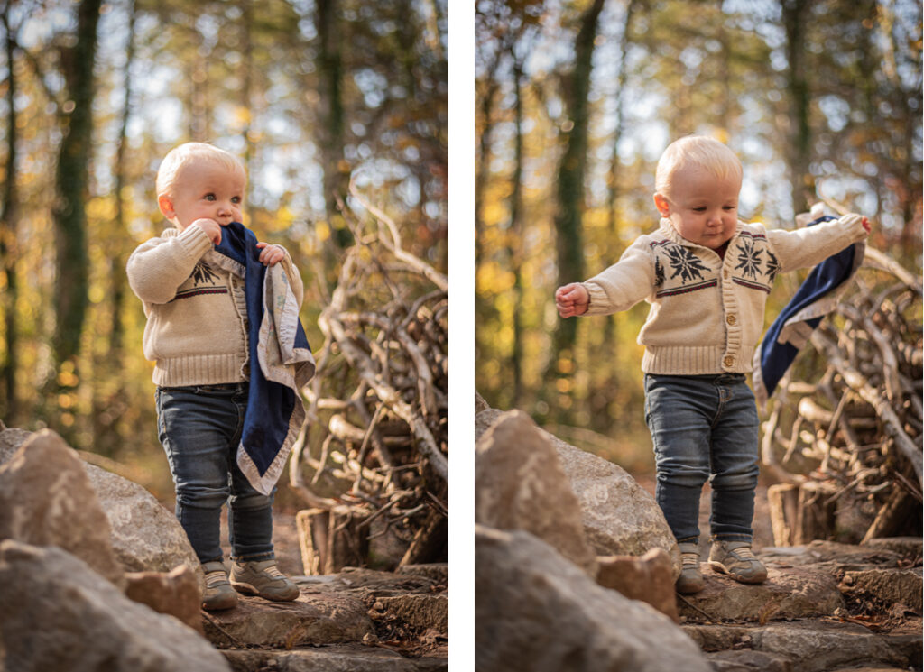 A baby boy stands on top of a stone staircase in the woods.